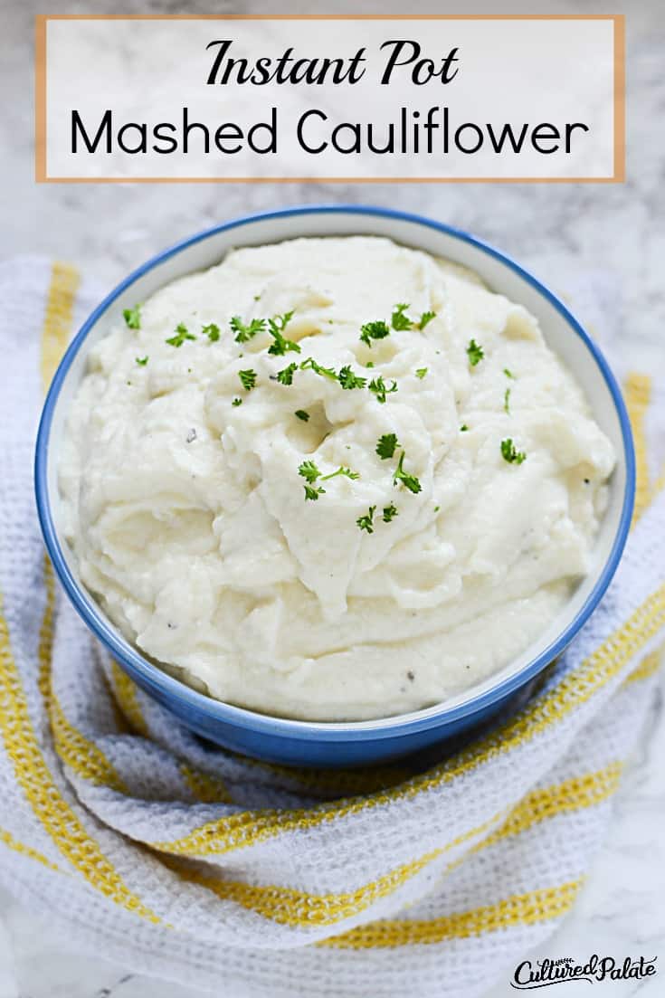 Vertical image titled "Instant Pot Mashed Cauliflower Recipe" with white bowl of mashed cauliflower potatoes on yellow and white striped towel.