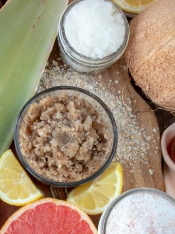 Homemade Sugar Scrubs shown from overhead with ingredients around the jars.