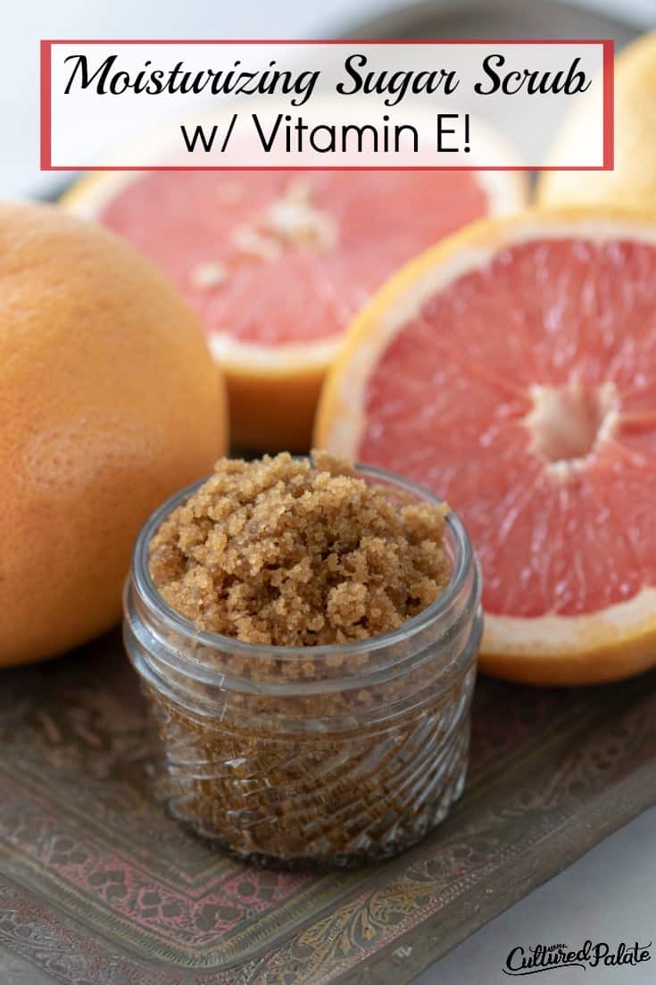 Moisturizing Sugar Scrub shown in glass jar with grapefruit around on tile with text overlay.