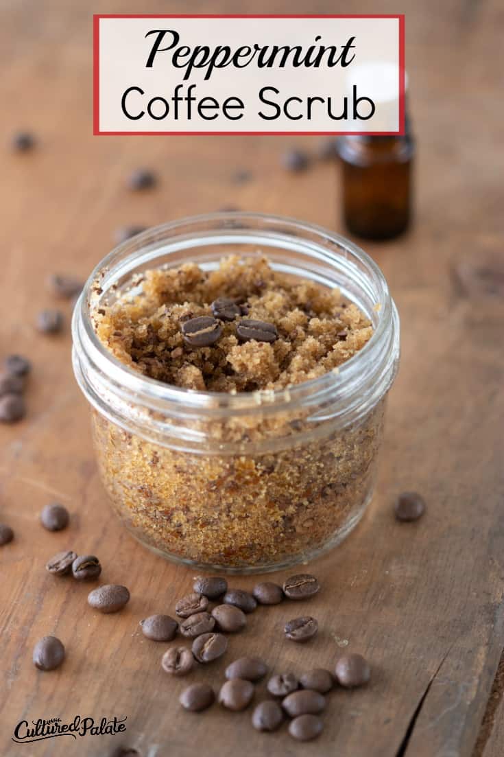 Peppermint Coffee Scrub shown in glass jar with coffee beans and essential oil around it on wood table with text overlay.