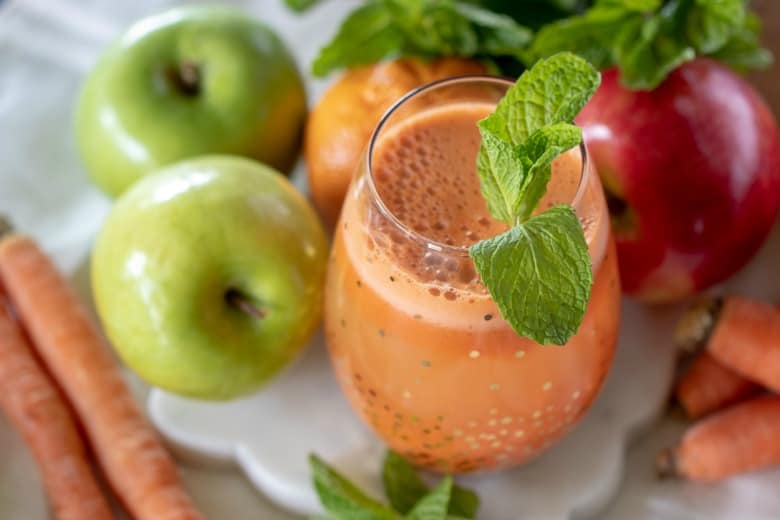 Cold Pressed Carrot Juice Recipe shown in gold accented glass.