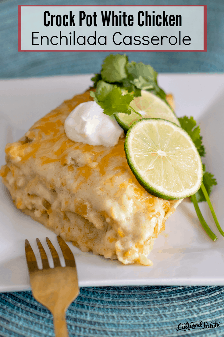 A piece of Crockpot White Chicken Enchilada Casserole on a white plate with fork to the side with text overlay.