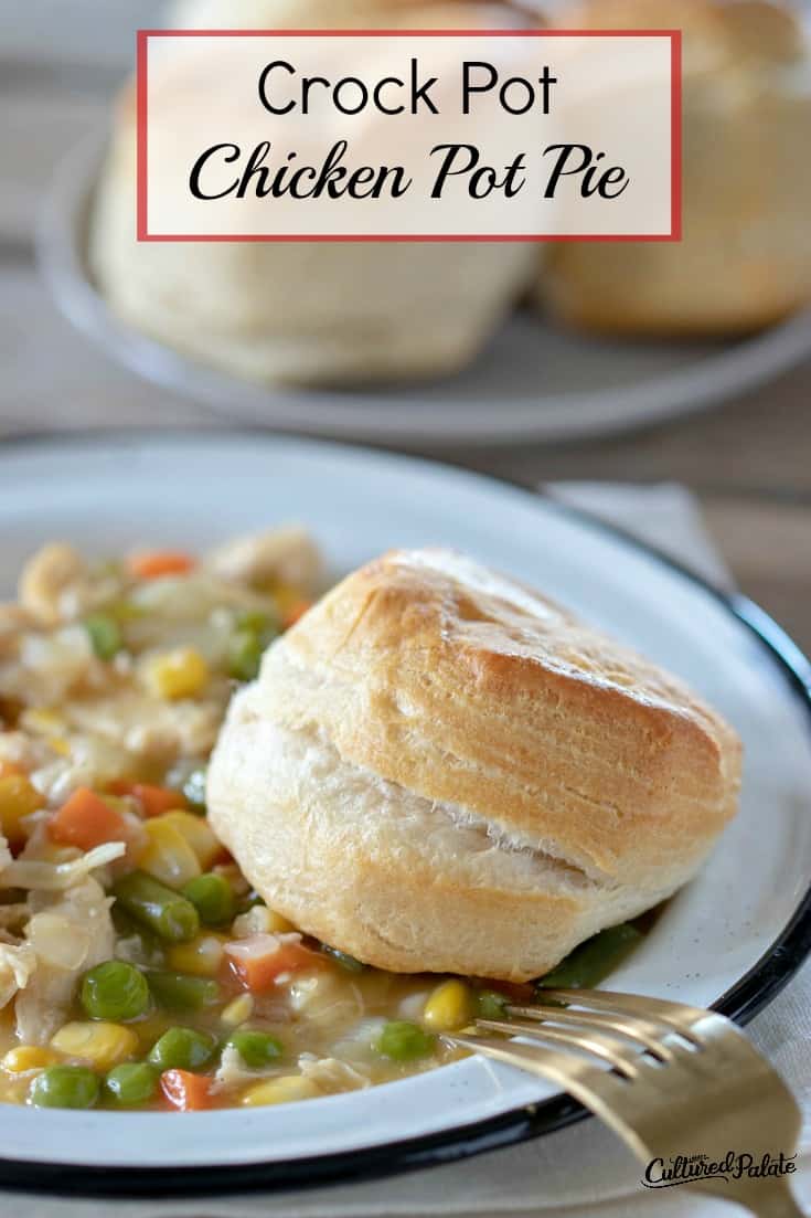 Crockpot Chicken Pot Pie shown with biscuit on the side of the white bowl and in the background.