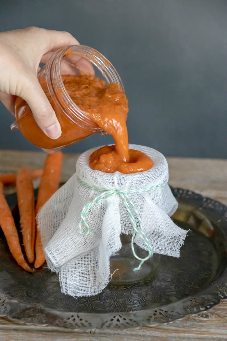 Carrot Juice pulp being poured through strainer from the post "How to Make Pure Carrot Juice"