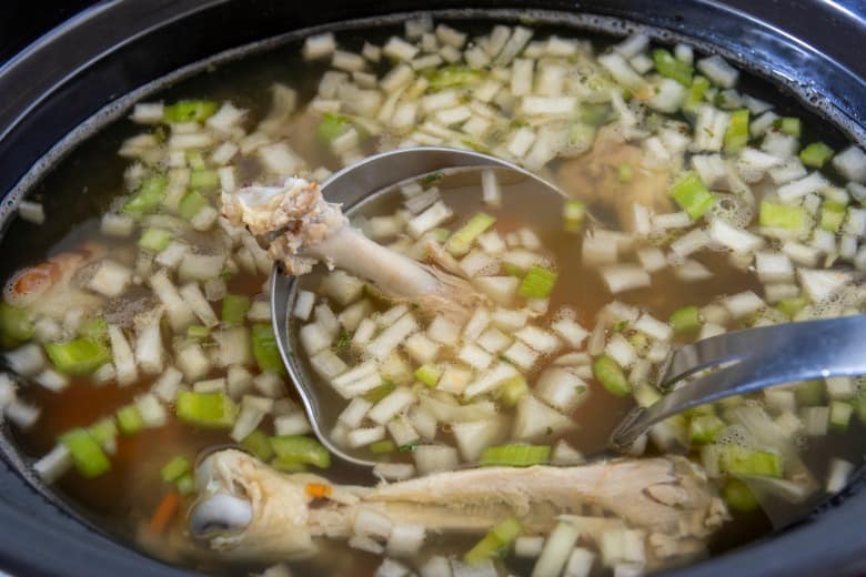 All ingredients in the crockpot to make bone broth.