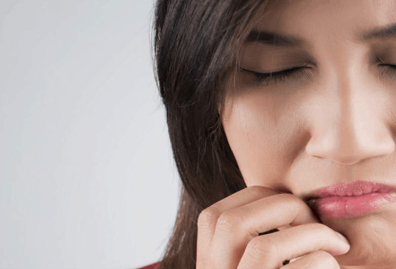 Woman in pain from her mouth shown in horizontal image.