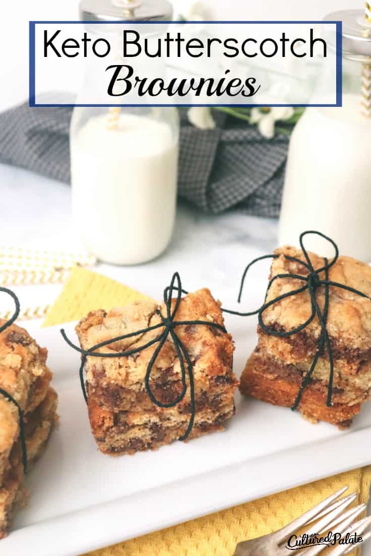 Keto Butterscotch Bars shown lined up on white plate with milk glasses in the background.