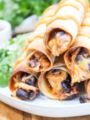 taquitos stacked on a plate