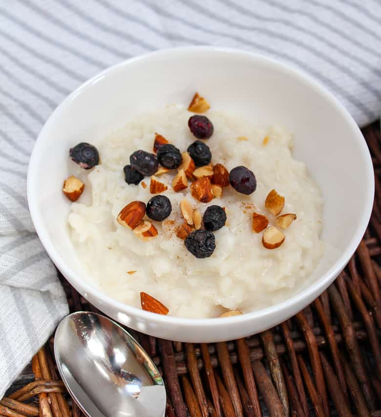 rice in a bowl with blueberries and almonds