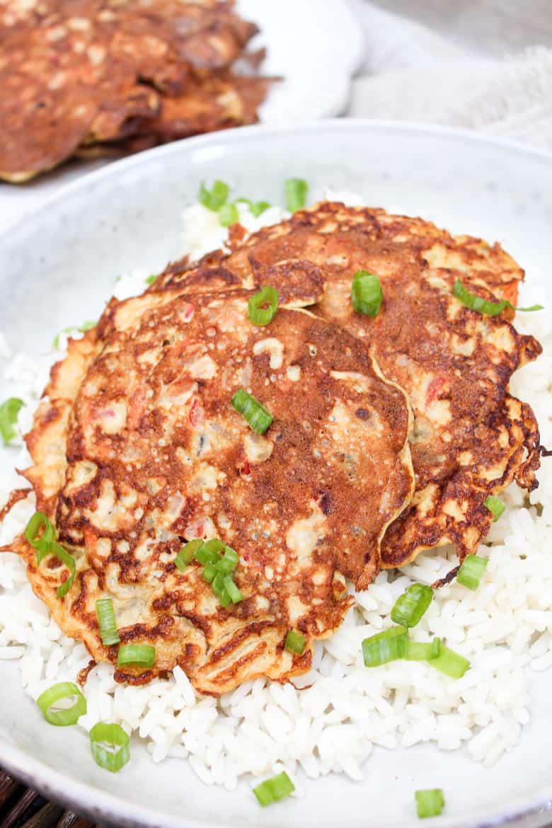 Egg Foo Yound pancakes over rice in a bowl