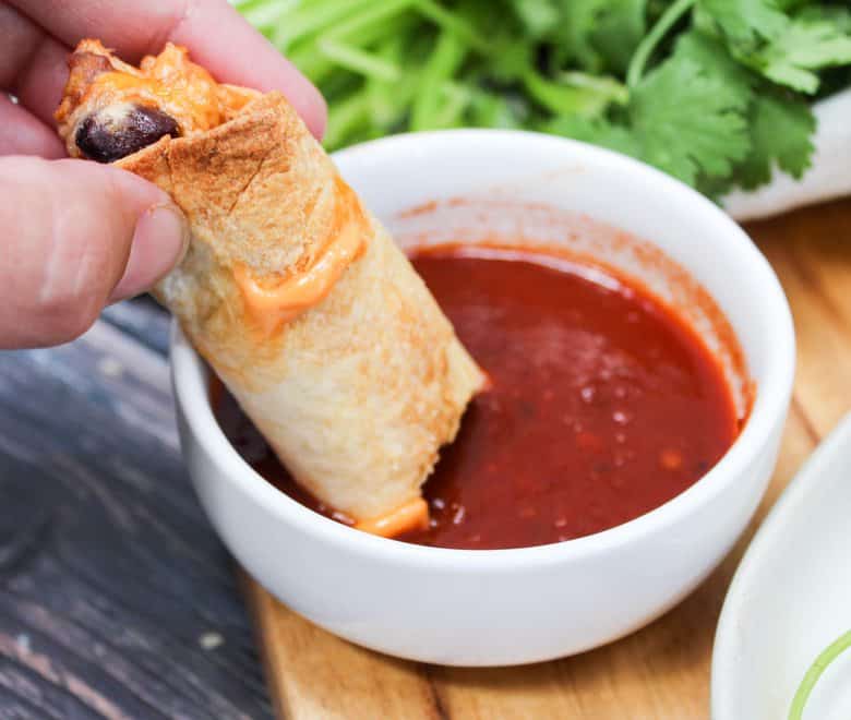 Oven Baked Chipotle Chicken Taquitos dipped is salsa